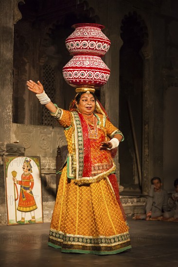 UDAIPUR, INDIA, NOVEMBER 24: Bhavai performance, famous folk dance of Rajasthan state of India. Performer balances number of earthen pots as she dance. November 24, 2012 in Udaipur, Rajasthan, India, Asia