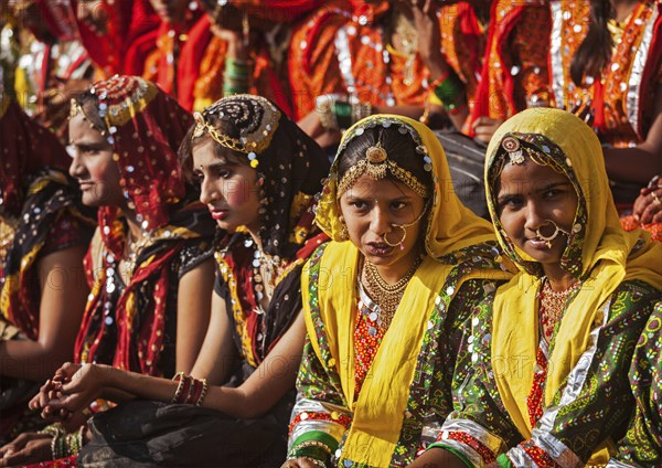 PUSHKAR, INDIA, NOVEMBER 21, 2012: Unidentified Rajasthani girls in traditional outfits prepare for dance perfomance at annual camel fair Pushkar Mela in Pushkar, Rajasthan, India, Asia