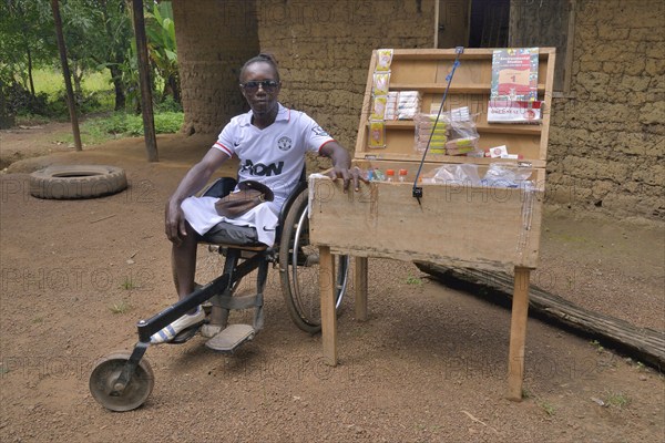 Amputee sitting in for his mobile shop, Motema Amputee Camp, Koidu, Koidu-Sefadu, Kono District, Eastern Province, Sierra Leone, Africa