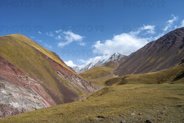 Valley with mountain stream between high mountains in autumn, mountain landscape with glaciated peak Pik ITMO University, Trans Alay Mountains, Pamir Mountains, Osh Province, Kyrgyzstan, Asia