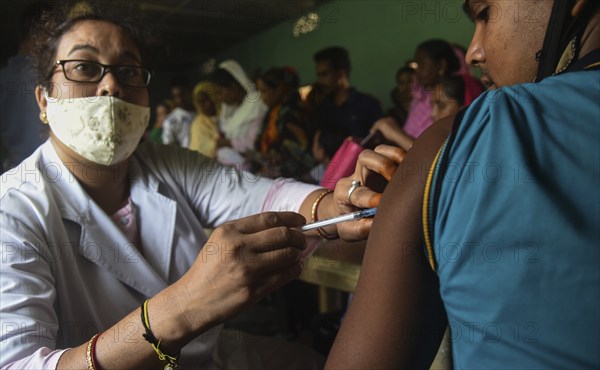 Beneficiaries receives dose of COVID-19 coronavirus vaccine in a vaccination centre at a village in Barpeta, Assam, India on 20 September 2021