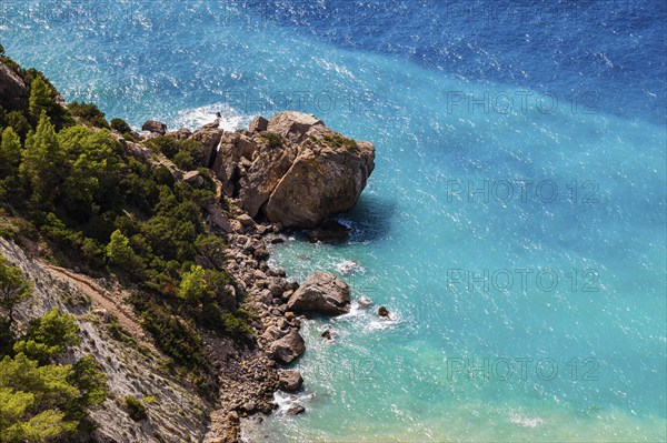 Boulders in turquoise-coloured water at Cap Blanc, Ibiza, Balearic Islands, Mediterranean Sea, Spain, Europe