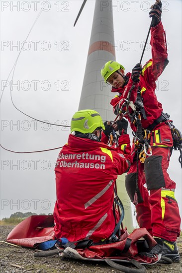 Height rescuers from the Oberhausen professional fire brigade practise abseiling from a wind turbine from a height of 150 metres, rescuing an injured person, technician, from the nacelle, Issum, North Rhine-Westphalia, Germany, Europe