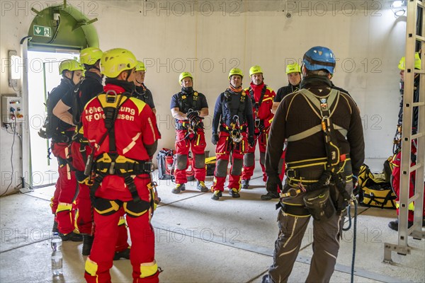 Height rescuers from the Oberhausen fire brigade practise abseiling from a wind turbine from a height of 150 metres, briefing on the turbine, in rainy weather, Issum, North Rhine-Westphalia, Germany, Europe