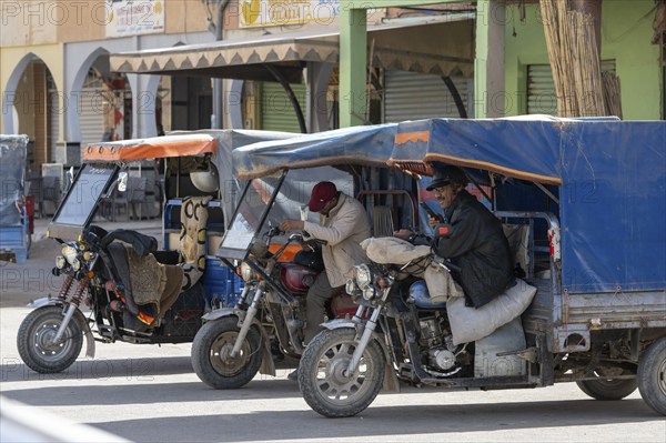 Street scene, Moroccan tuk tuks with driver, Merzouga, Morocco, Africa