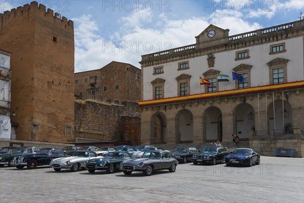 A square with classic cars and historic buildings in the background, town hall, Ayuntamiento, vintage cars, Plaza Mayor, Cáceres, Caceres, Extremadura, Spain, Europe