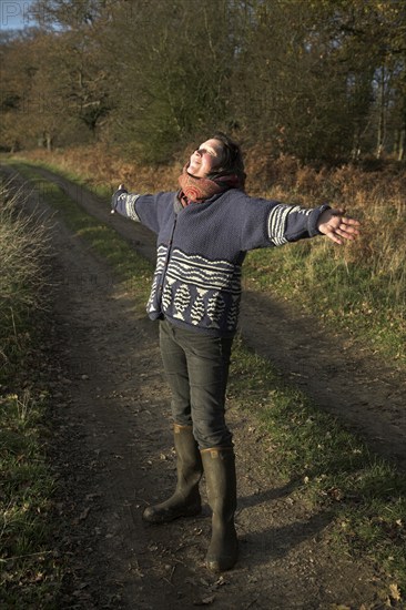 Model released woman enjoying winter sun in the countryside