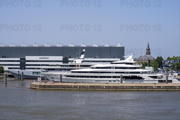 Oceanco shipyard in Alblasserdam, specialising in the construction of mega yachts, luxury yachts, on the river Noord, South Holland, in front the H3 yacht, 105 metres long, completely renovated, rebuilt, behind the superyacht Seven Seas Yacht, 109 metres long, owned by Steven Spielberg, Netherlands