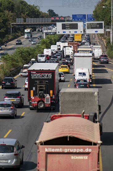 Traffic jam on the A3 motorway, over 8 lanes, in both directions, in front of the Leverkusen motorway junction, Friday afternoon high traffic volume, roadworks, gantry signs with journey times, delays due to the traffic jam, Leverkusen, North Rhine-Westphalia, Germany, Europe