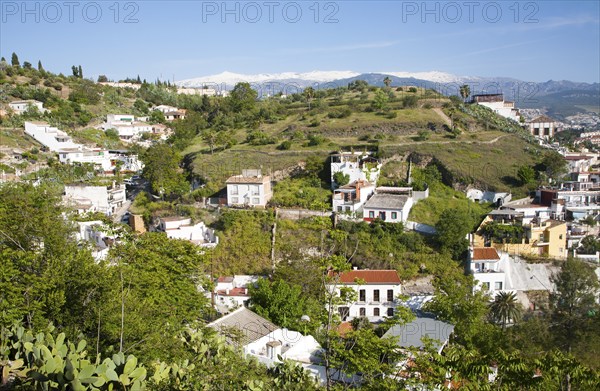 Residential suburban housing area in Granada, Spain with snow capped Sierra Nevada mountains in background