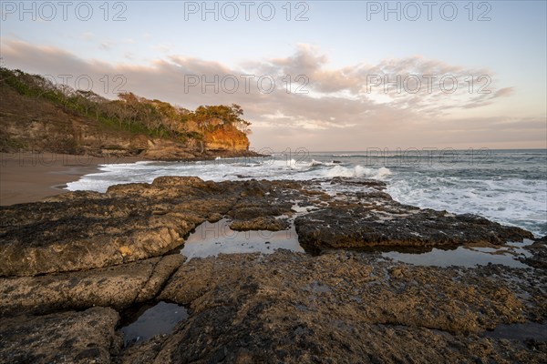 Sandy beach beach with rocks and sea at sunset, Playa Cocalito, coastal landscape, Pacific coast, Nicoya Peninsula, Puntarenas Province, Costa Rica, Central America