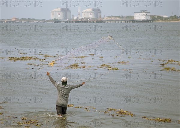 Indian fisherman throws his net into the Arabian Sea, Kochi, Kerala, India, Asia