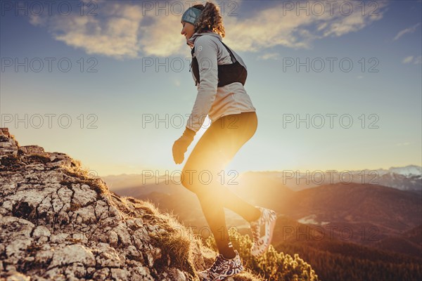 Trail running in autumn on the Jochberg on Lake Walchensee against the wonderful backdrop of the Alps, Bavaria, Germany, Europe