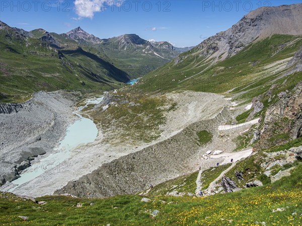 Hiking trail up to mountain hut Cabane de Moiry, glacial moraine, lake Lac de Moiry in the back, Valais, Switzerland, Europe