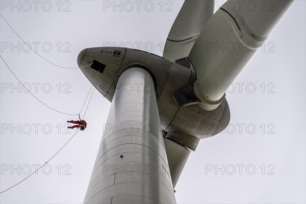 Height rescuers from the Oberhausen fire brigade practise abseiling from a wind turbine from a height of 150 metres after rescuing an accident victim from the nacelle, Issum, North Rhine-Westphalia, Germany, Europe