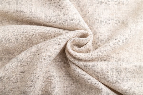 Fragment of white linen tissue. Side view, natural textile background and texture. wave concept, abstract, spiral form