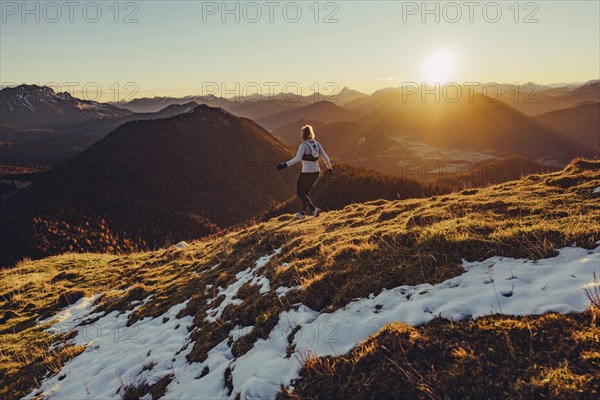 Trail running in autumn on the Jochberg on Lake Walchensee against the wonderful backdrop of the Alps, Bavaria, Germany, Europe