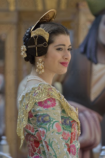 Fallas festival, woman in a traditional costume during the parade in the Plaza de la Virgen de los Desamparados, Valencia, Spain, Europe