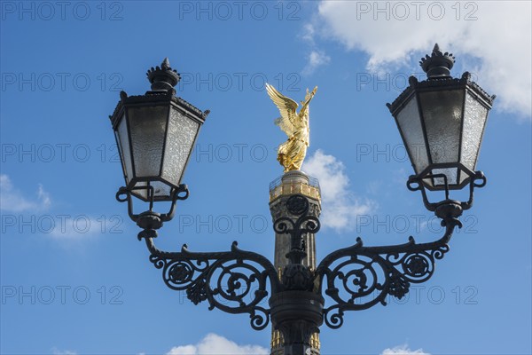 Victory Column behind a beautiful, old street lamp in a blue sky with white clouds, towering column with angel figure, angel, bronze sculpture, bronze, Victory Column on the Great Star with gilded, winged goddess of victory Victoria (artist: Friedrich Drake), in Berlin vernacular also Goldelse, national monument, sight, Großer Tiergarten, Berlin Mitte, city of Berlin, Germany, Europe