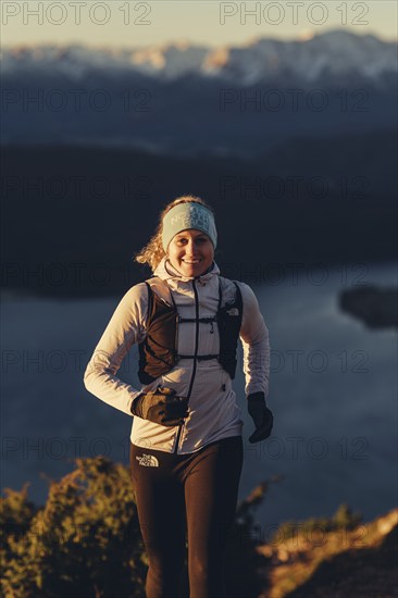 Trail running in autumn on the Jochberg on Lake Walchensee against the wonderful backdrop of the Alps, Bavaria, Germany, Europe