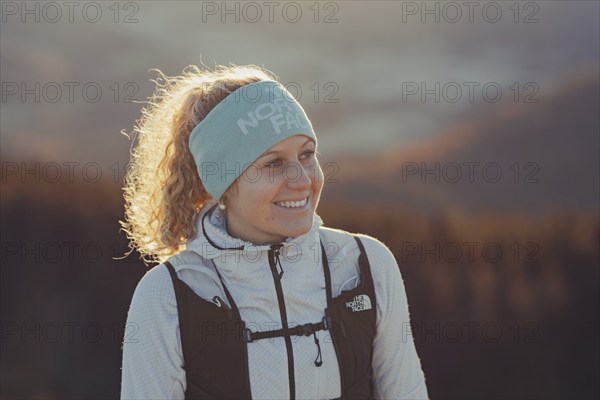 Trail running in autumn on the Jochberg on Lake Walchensee against the wonderful backdrop of the Alps, Bavaria, Germany, Europe