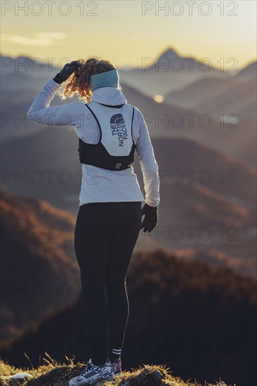 Trail running in autumn on the Jochberg on Lake Walchensee against the wonderful backdrop of the Alps, Bavaria, Germany, Europe