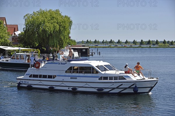 Europe, Germany, Mecklenburg-Western Pomerania, island town of Malchow, Lake Malchow, at the swing bridge, motor yacht, Malchow, Mecklenburg-Western Pomerania, Germany, Europe