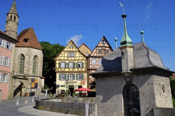 The Henkersbrücke bridge in Schwäbisch Hall spans the River Kocher. Opposite the Johanniter church and an arrangement of beautiful half-timbered houses. Landscape format. The hangman's bridge in Schwäbisch Hall spans the river Kocher. Opposite the Johanniterkirche and an arrangement of beautiful half-timbered houses. Horizontal format