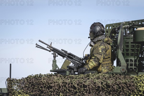 A Czech soldier occupies the hatch of a protected vehicle as part of the military exercise 'Wettiner Schwert' near Tangermünde, 26 March 2024. 'Wettiner Schwert' is part of the Quadriga exercise of the German Armed Forces and the NATO large-scale manoeuvre Steadtfast Defender 2024