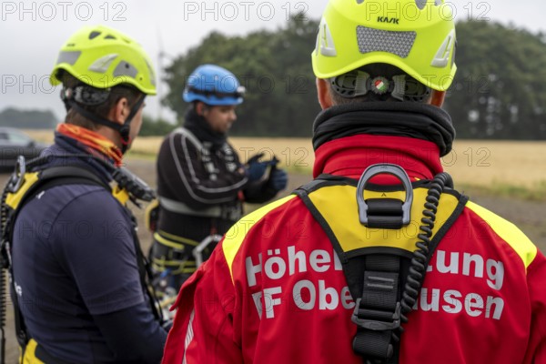 Height rescuers from the Oberhausen fire brigade practise abseiling from a wind turbine from a height of 150 metres, briefing on the turbine, in rainy weather, Issum, North Rhine-Westphalia, Germany, Europe