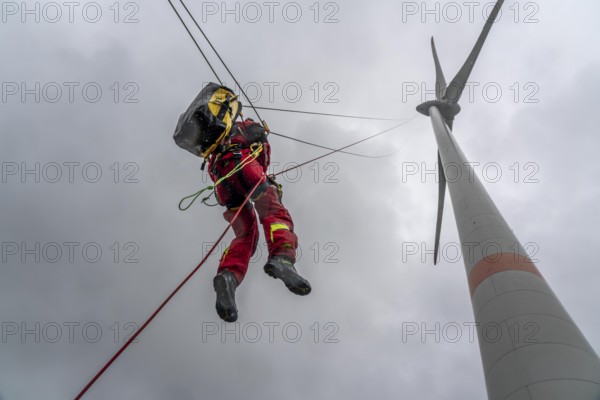 Height rescuers from the Oberhausen fire brigade practise abseiling from a wind turbine from a height of 150 metres after rescuing an accident victim from the nacelle, Issum, North Rhine-Westphalia, Germany, Europe