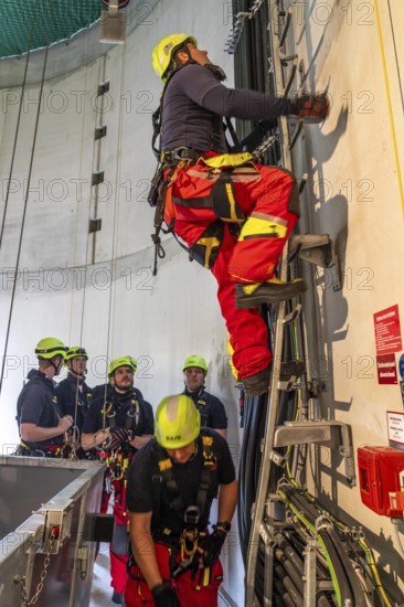 Height rescuers from the Oberhausen professional fire brigade practise abseiling from a wind turbine from a height of 150 metres, ascent into the turbine, to the nacelle, Issum, North Rhine-Westphalia, Germany, Europe