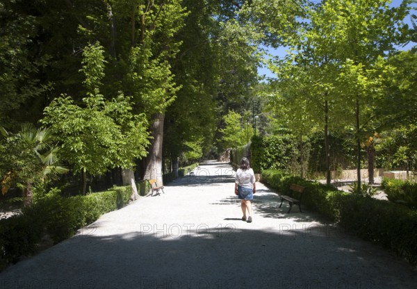 Woman walking in the gardens of the Balneario de Granada hotel, Alhama de Granada, Spain, Europe