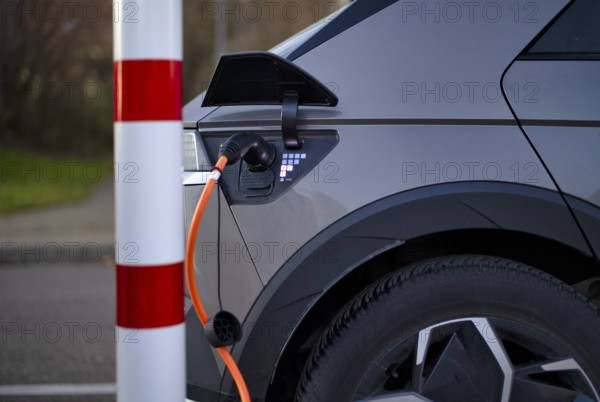 E-vehicle Hyundai IONIQ 5 at charging station for electric cars, charging station, e-mobility, charging cable leads into e-car, charge level indicator, Stuttgart, Baden-Württemberg, Germany, Europe