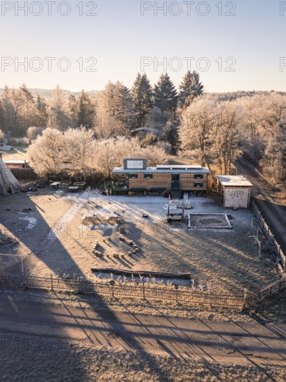 Caravan and tipi surrounded by frost-covered trees in the morning sun, Kita, Gechingen, Hecken und Gäu Region, Landkreis Calw, Schwarzwald. Germany