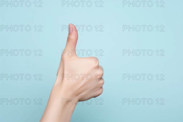 Woman's hand showing thumbs up on blue background. KI generiert, generiert, AI generated