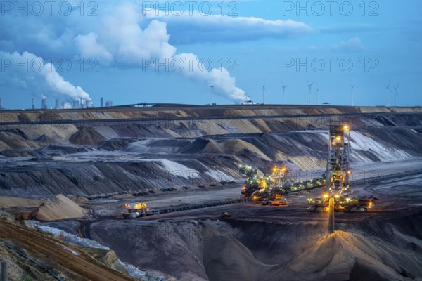 Garzweiler II open-cast lignite mine, excavator filling up the pit on the eastern edge of the open-cast mine, wind farm. Neurath power station