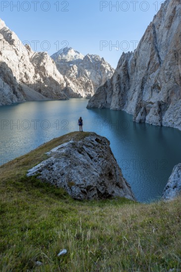 Hiker in front of Kol Suu Mountain Lake, Kol Suu Lake, Sary Beles Mountains, Naryn Province, Kyrgyzstan, Asia