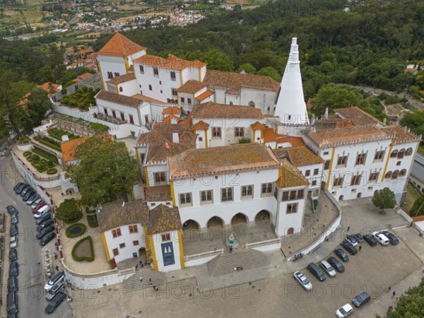 Aerial view of a historic castle with striking white towers and surrounding gardens, Royal Palace, Palácio Nacional de Sintra, National Palace, Sintra, Lisbon, Portugal, Europe