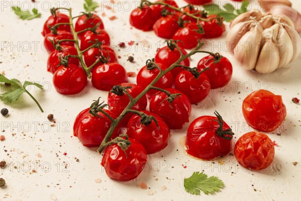 Baked branch, mini, cherry tomatoes, with spices and herbs, garlic, food background, top view, on a white background