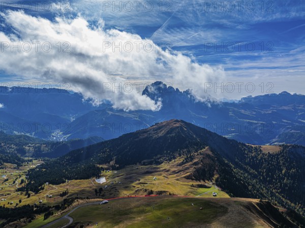 The Picberg, behind it the peaks of the Sassolungo Group, shrouded in mist, drone shot, Val Gardena, Dolomites, Autonomous Province of Bolzano, South Tyrol, Italy, Europe