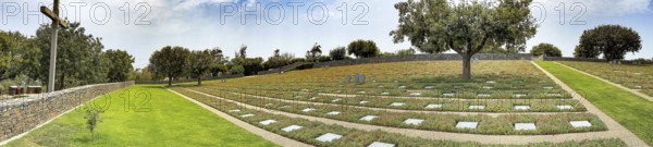 Panoramic photo wide view over part of German military cemetery inaugurated in 1974 by Volksbund Deutsche Kriegsgräberfürsorge on former battlefield in World War II heavily contested hill Height 107, Maleme, Crete, Greece, Europe