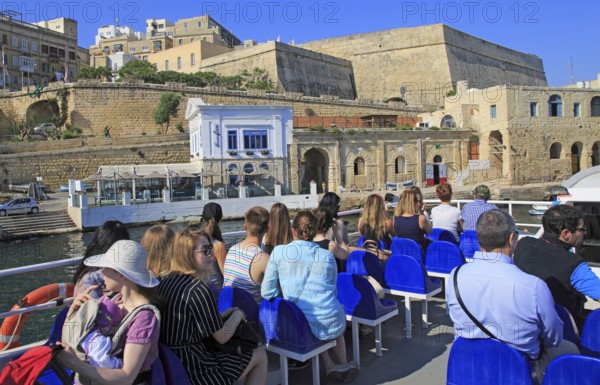 People onboard ferry boat crossing harbour from Sliema to Valletta, Malta, Europe