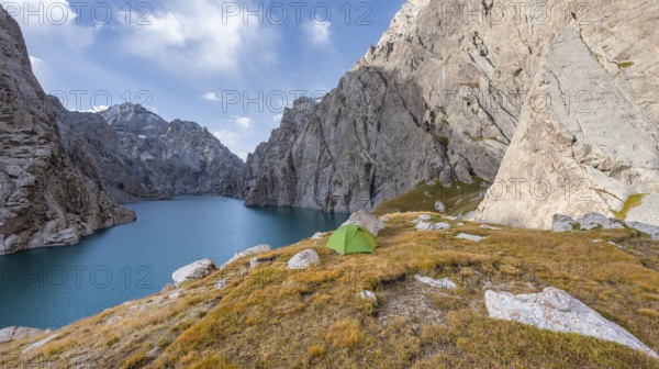 Green tent by a blue mountain lake between steep rocky mountain peaks, Kol Suu Lake, Sary Beles Mountains, Naryn Province, Kyrgyzstan, Asia