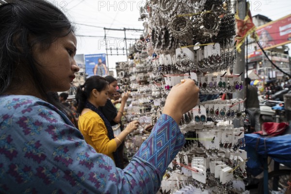 Women buys jewelleries at street market ahead of Durga Puja festival on October 7, 2024 in Guwahati, India. Shopping ahead of Durga Puja is a major event, as people prepare for the celebration