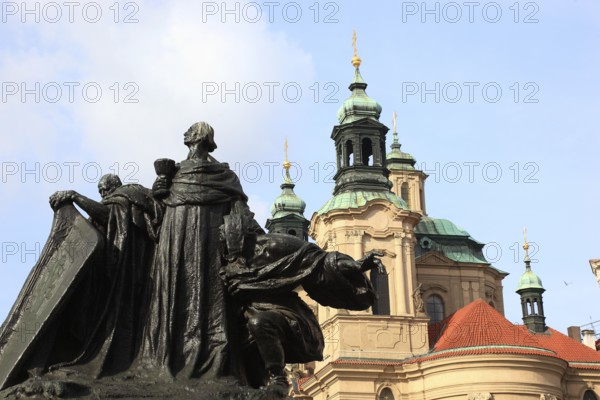 Jan Hus Monument on Old Town Square and the baroque St Nicholas Church, Prague, Czech Republic, Europe