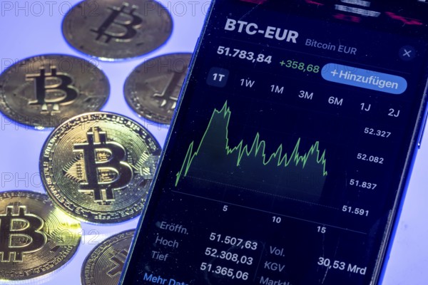 Bitcoin cryptocurrency, symbol coin, mobile phone, mobile phone with Bitcoin exchange rates, to the euro, optical placeholder for the digital currency, blockchain, stock exchange rates