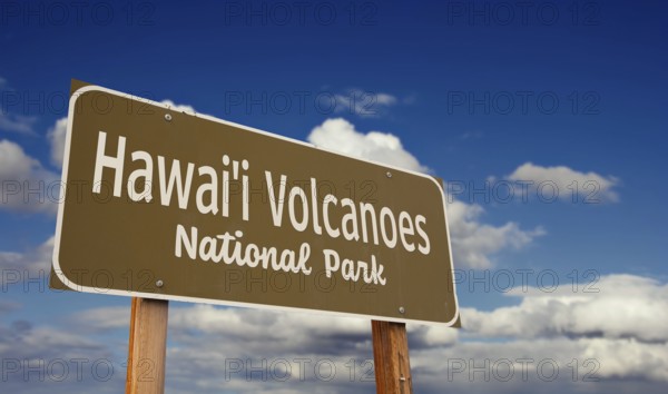 Hawai'i volcanoes national park (hawaii) road sign against blue sky and clouds