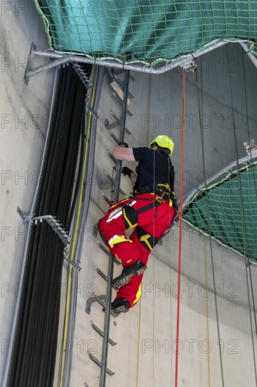 Height rescuers from the Oberhausen professional fire brigade practise abseiling from a wind turbine from a height of 150 metres, ascent into the turbine, to the nacelle, Issum, North Rhine-Westphalia, Germany, Europe