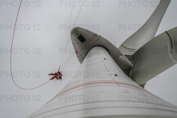 Height rescuers from the Oberhausen fire brigade practise abseiling from a wind turbine from a height of 150 metres after rescuing an accident victim from the nacelle, Issum, North Rhine-Westphalia, Germany, Europe